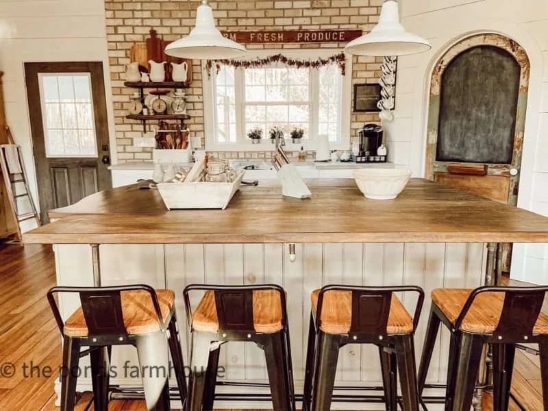 An inviting farmhouse kitchen island, featuring ample storage and a cozy gathering spot for family and friends.