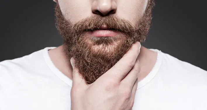 Close-up shot of a well-kept medium style beard, showcasing precision grooming and masculine appeal.